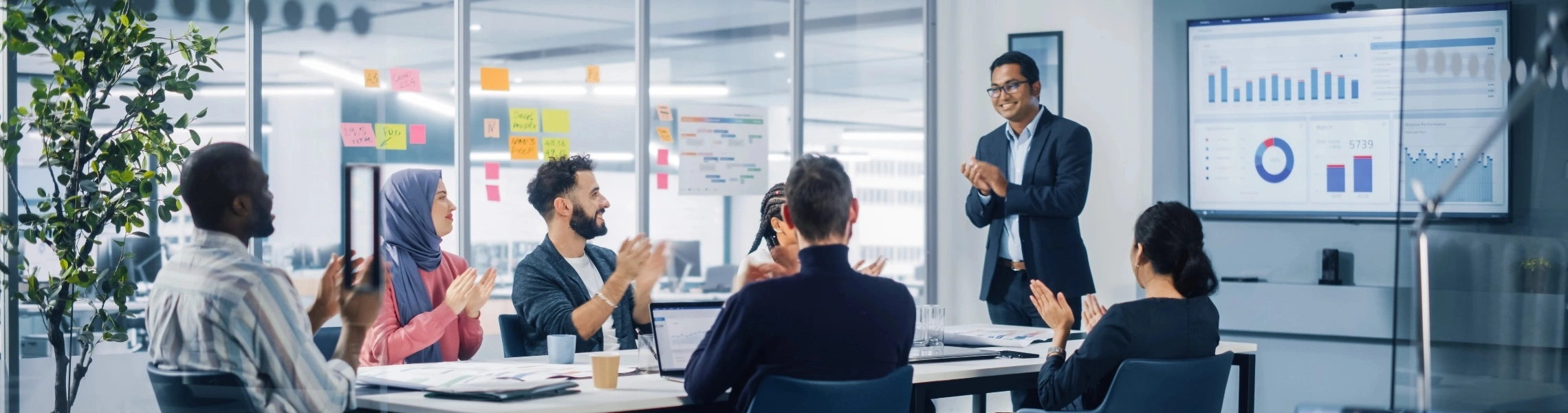 A group of diverse individuals gathered in a meeting room