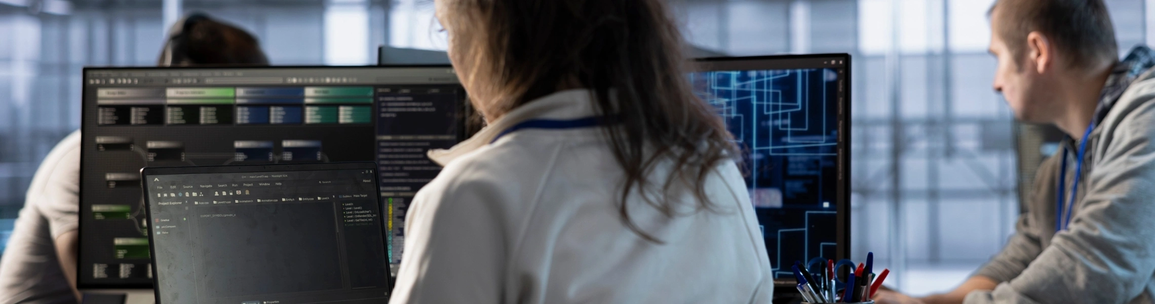 A man and woman are collaborating as they look at a computer screen