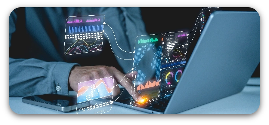 A person focused on a laptop, interacting with a vibrant digital display on the screen