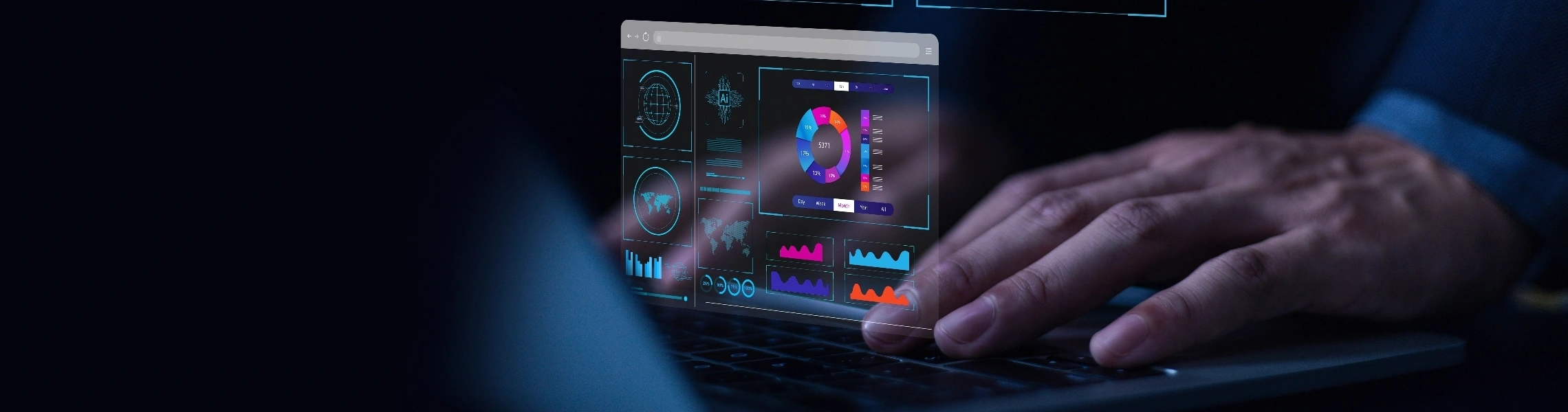 A person types on a laptop, with a colorful graphic displayed on the screen