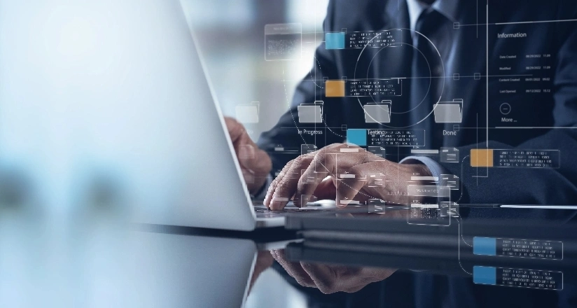 Business professionals collaborating on laptops in a modern office setting and hold a pen