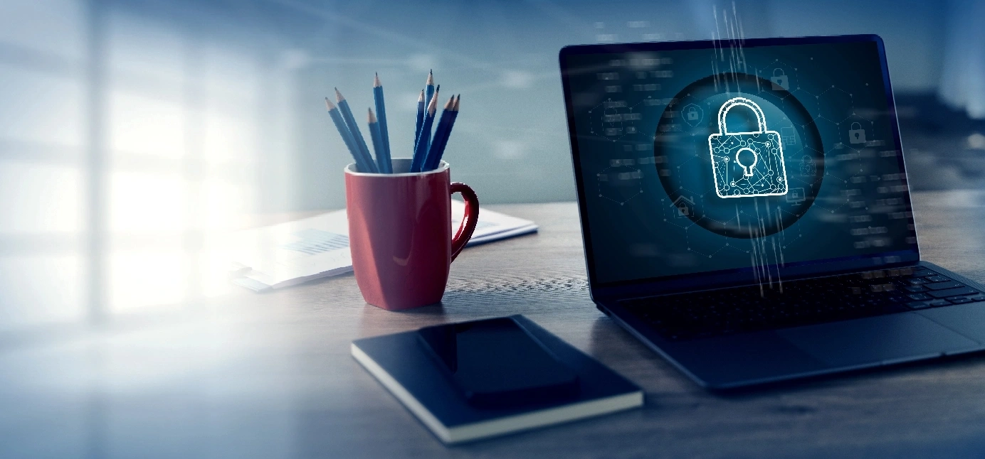 Security concept displayed on a laptop screen, featuring a lock symbol and digital elements representing cybersecurity
