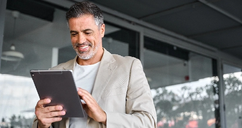 men holding a tablet and smile