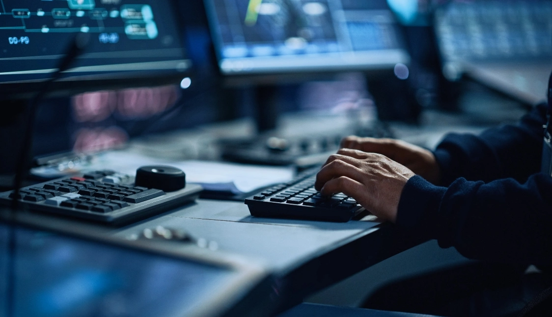 person typing on keyboard in office